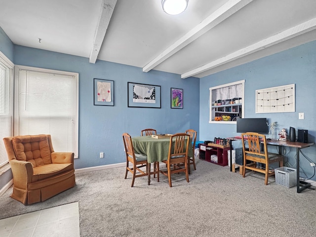 carpeted dining space featuring baseboards and beam ceiling