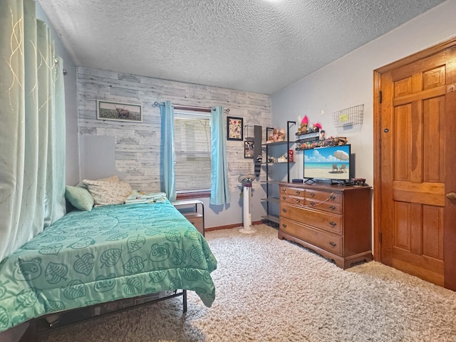 carpeted bedroom featuring baseboards and a textured ceiling
