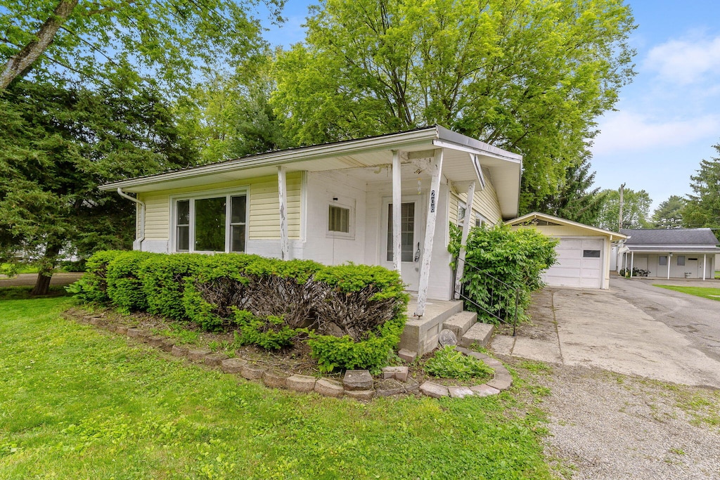 208 Pickrelltown St, West Liberty, OH 43357 - ranch-style house featuring driveway and a front lawn