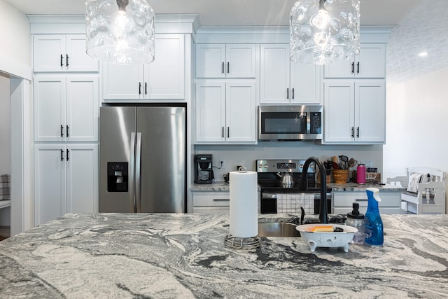 210 N Branch, Tipp City, OH 45371 - kitchen featuring stainless steel appliances, light stone counters, white cabinets, and pendant lighting