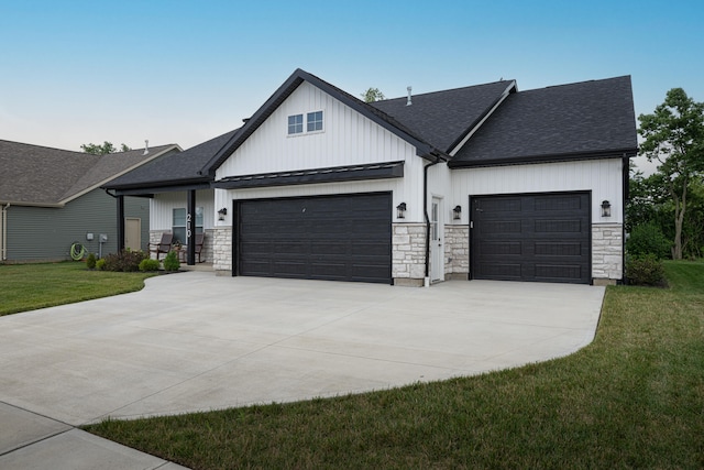 210 N Branch, Tipp City, OH 45371 - modern farmhouse featuring a garage, driveway, stone siding, and roof with shingles