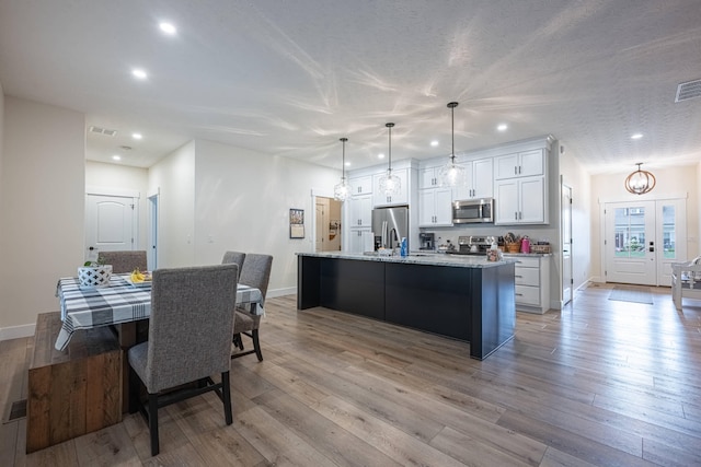 210 N Branch, Tipp City, OH 45371 - kitchen featuring stainless steel appliances, a chandelier, recessed lighting, a kitchen island with sink, and white cabinetry