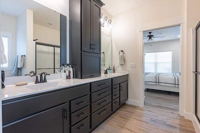 210 N Branch, Tipp City, OH 45371 - full bathroom with ceiling fan, double vanity, wood finished floors, a textured ceiling, and ensuite bath
