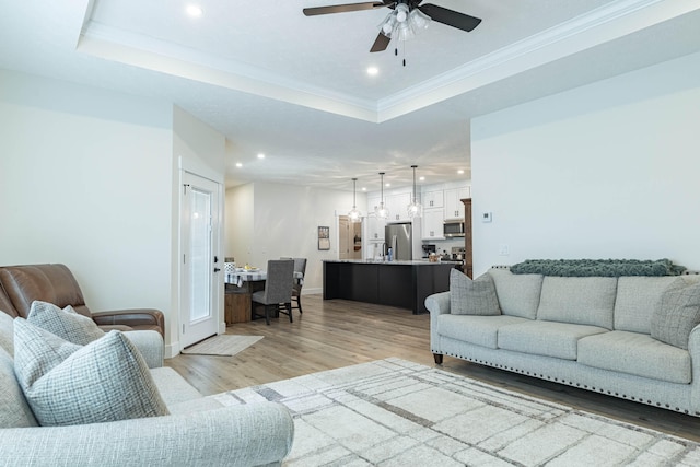 210 N Branch, Tipp City, OH 45371 - living room featuring recessed lighting, light wood-style flooring, a tray ceiling, ceiling fan, and crown molding