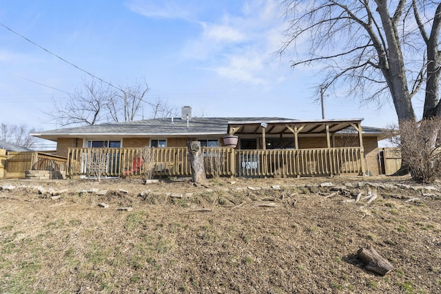 rear view of property with a wooden deck