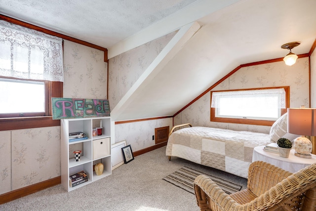 bedroom featuring multiple windows, vaulted ceiling, carpet flooring, and a textured ceiling