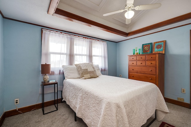 carpeted bedroom with crown molding, ceiling fan, and a raised ceiling