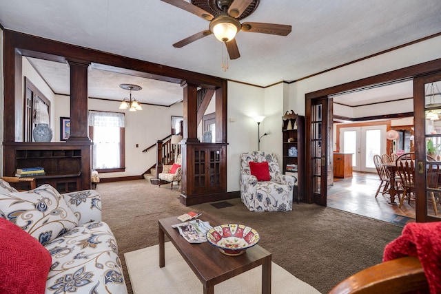 living room featuring carpet, french doors, and ornate columns