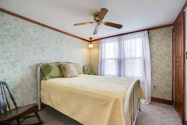 bedroom featuring ceiling fan, crown molding, and carpet floors