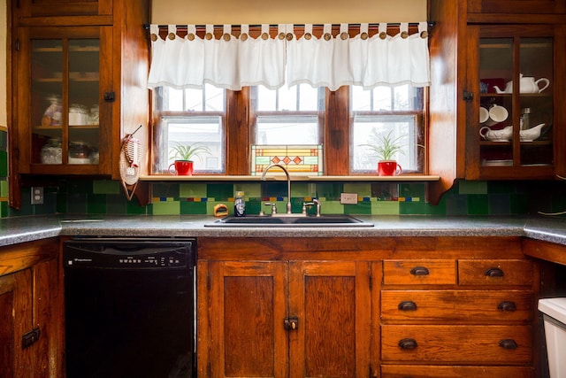 kitchen with sink, black dishwasher, and tasteful backsplash