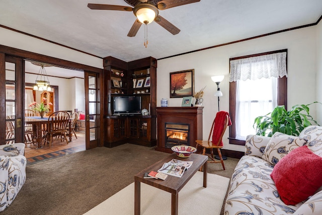 carpeted living room featuring ornamental molding and ceiling fan