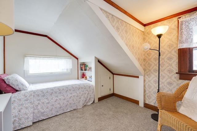 bedroom with ornamental molding, vaulted ceiling, and carpet flooring