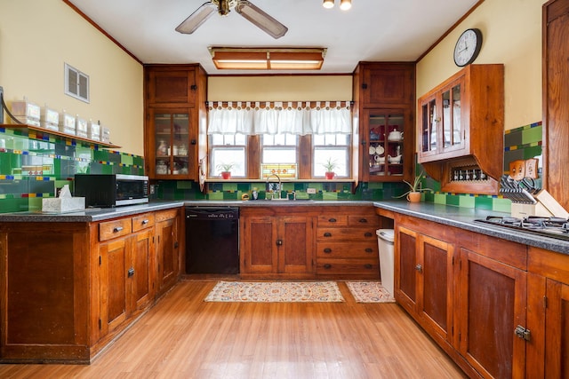 kitchen featuring ornamental molding, sink, black dishwasher, and gas stovetop