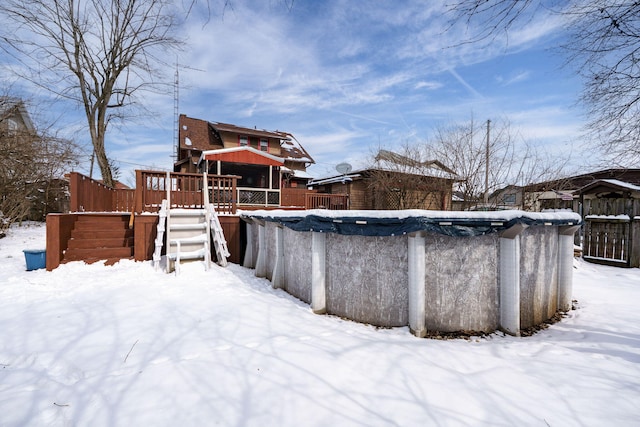 snow covered pool featuring a wooden deck