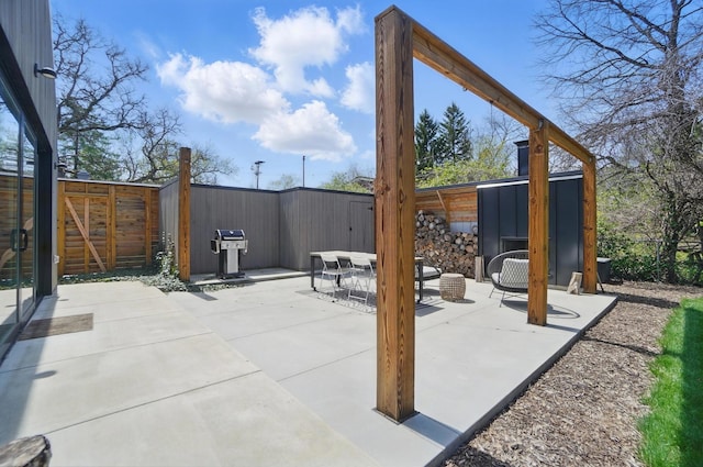 view of patio / terrace featuring a fenced backyard and a grill