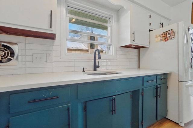 202 Fairfield Pike Unit A, Yellow Springs, OH 45387 - kitchen featuring a sink, tasteful backsplash, freestanding refrigerator, and blue cabinets