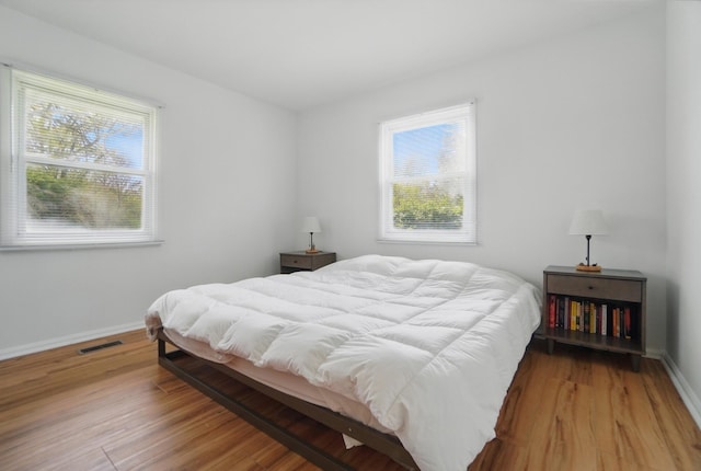 202 Fairfield Pike Unit A, Yellow Springs, OH 45387 - bedroom featuring multiple windows, wood finished floors, and visible vents