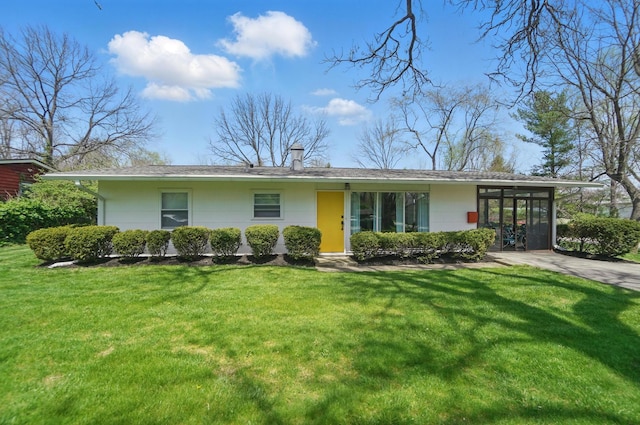 view of front of home with a chimney and a front yard
