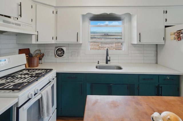 kitchen featuring white appliances, under cabinet range hood, a sink, and light countertops