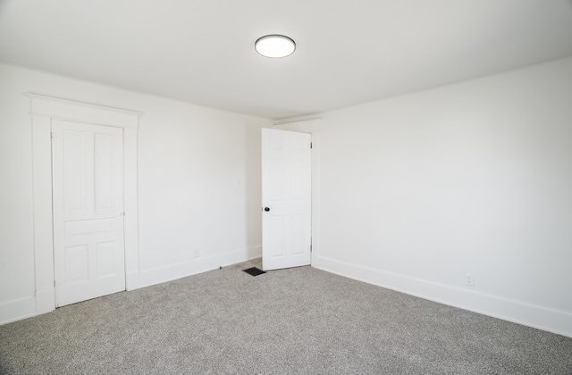 interior space featuring carpet and baseboards