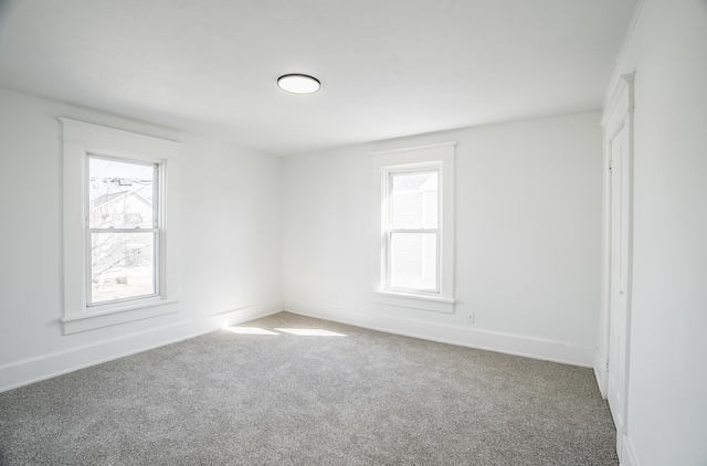 unfurnished room featuring carpet flooring and baseboards