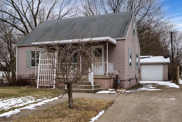 view of front facade with a garage, roof with shingles, and driveway