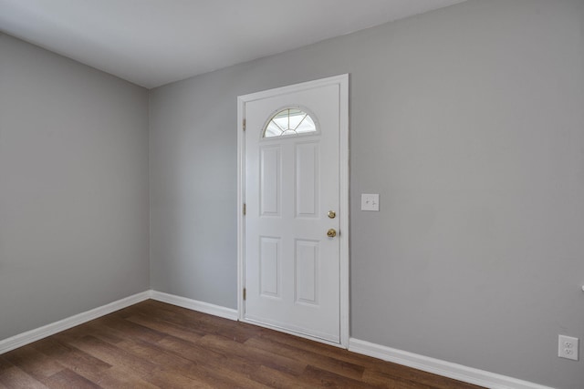 foyer entrance with dark wood-type flooring and baseboards