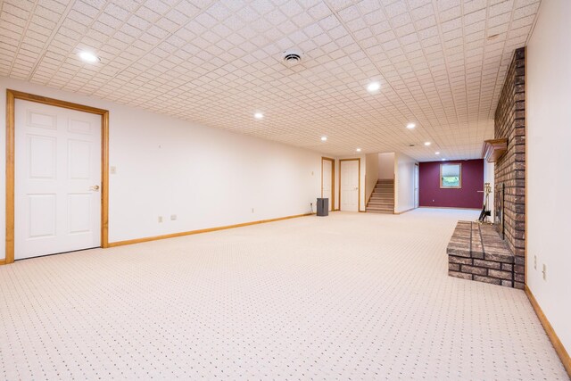 129 Tanglewood Dr, West Liberty, OH 43357 - finished basement with light carpet, stairway, recessed lighting, and baseboards