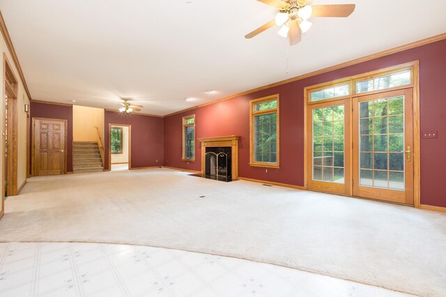 129 Tanglewood Dr, West Liberty, OH 43357 - unfurnished living room with a ceiling fan, crown molding, carpet floors, stairs, and plenty of natural light