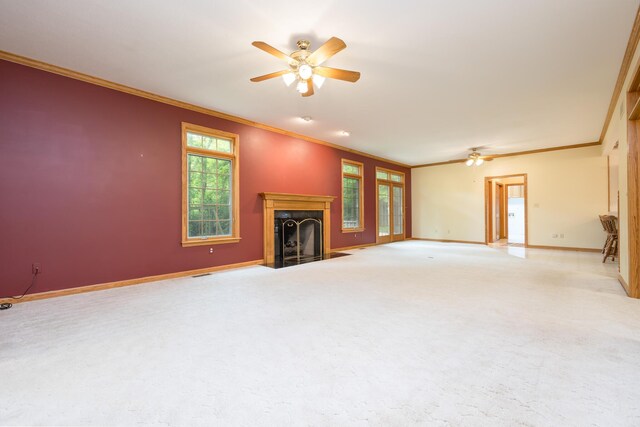 129 Tanglewood Dr, West Liberty, OH 43357 - unfurnished living room with ceiling fan, crown molding, a fireplace with flush hearth, baseboards, and carpet flooring