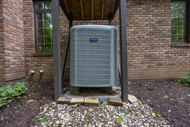 129 Tanglewood Dr, West Liberty, OH 43357 - exterior view of central AC unit and brick siding