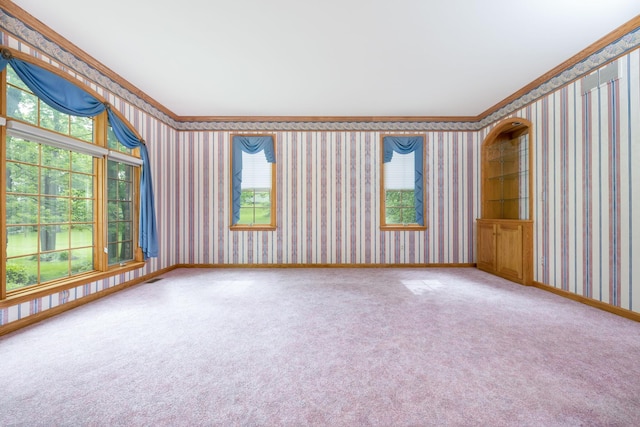 129 Tanglewood Dr, West Liberty, OH 43357 - empty room with crown molding, wallpapered walls, carpet floors, and baseboards