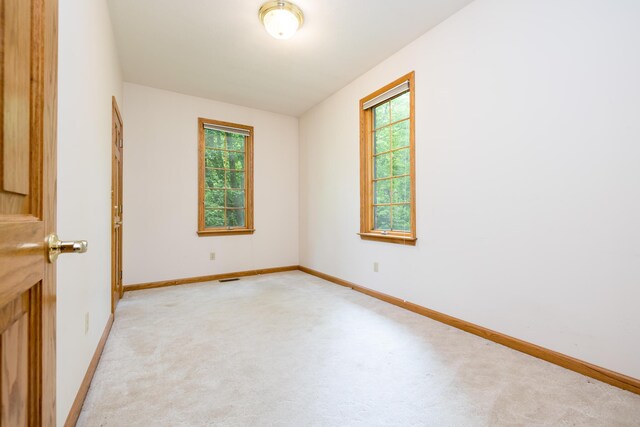129 Tanglewood Dr, West Liberty, OH 43357 - unfurnished room featuring plenty of natural light, light carpet, and baseboards