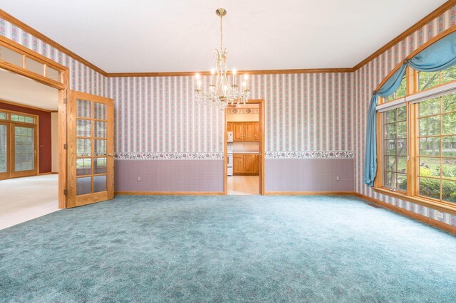 129 Tanglewood Dr, West Liberty, OH 43357 - carpeted empty room with wallpapered walls, a chandelier, plenty of natural light, crown molding, and french doors