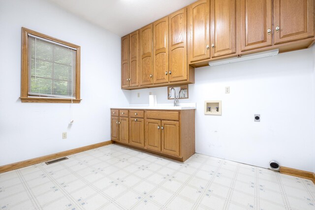 129 Tanglewood Dr, West Liberty, OH 43357 - laundry room featuring washer hookup, light flooring, hookup for an electric dryer, cabinet space, and baseboards