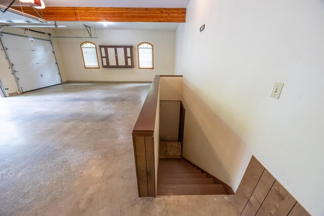 129 Tanglewood Dr, West Liberty, OH 43357 - stairway featuring concrete floors and beam ceiling