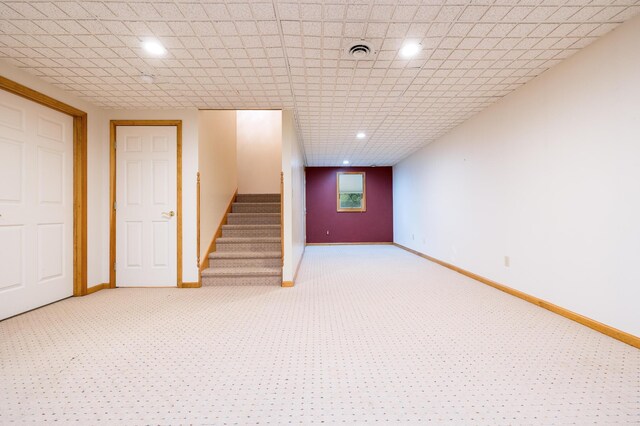 129 Tanglewood Dr, West Liberty, OH 43357 - finished below grade area featuring light carpet, stairs, and baseboards