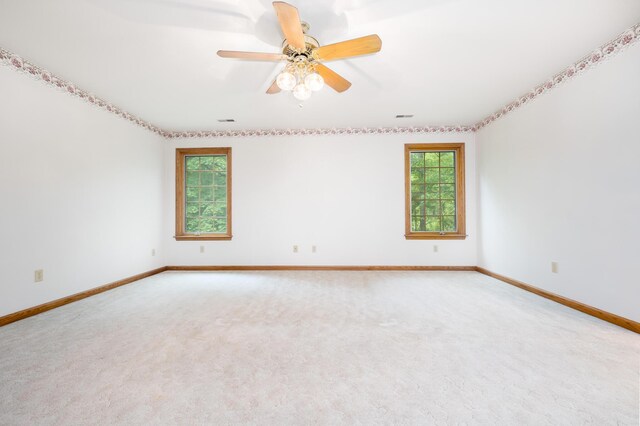 129 Tanglewood Dr, West Liberty, OH 43357 - carpeted spare room featuring healthy amount of natural light, baseboards, and a ceiling fan