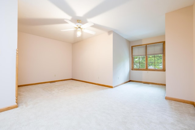 129 Tanglewood Dr, West Liberty, OH 43357 - spare room with light colored carpet, baseboards, and a ceiling fan
