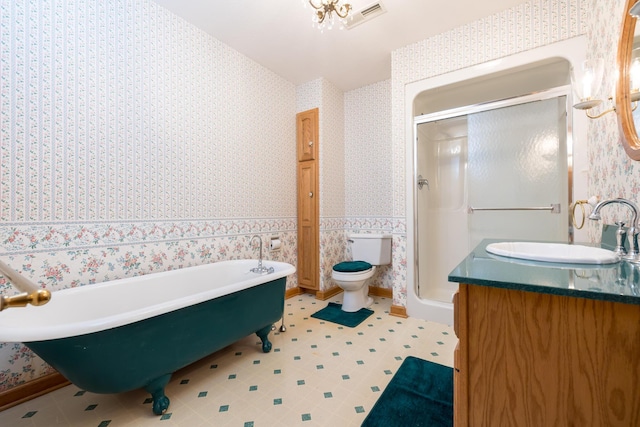 129 Tanglewood Dr, West Liberty, OH 43357 - bathroom with wallpapered walls, a shower stall, a freestanding tub, vanity, and toilet