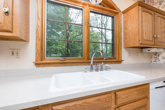 129 Tanglewood Dr, West Liberty, OH 43357 - kitchen with wallpapered walls, a sink, light countertops, and dishwasher
