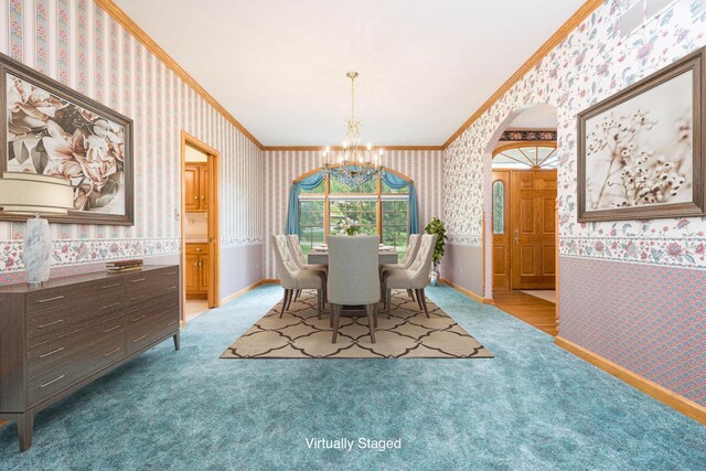 129 Tanglewood Dr, West Liberty, OH 43357 - carpeted dining room with wallpapered walls, ornamental molding, a chandelier, arched walkways, and baseboards
