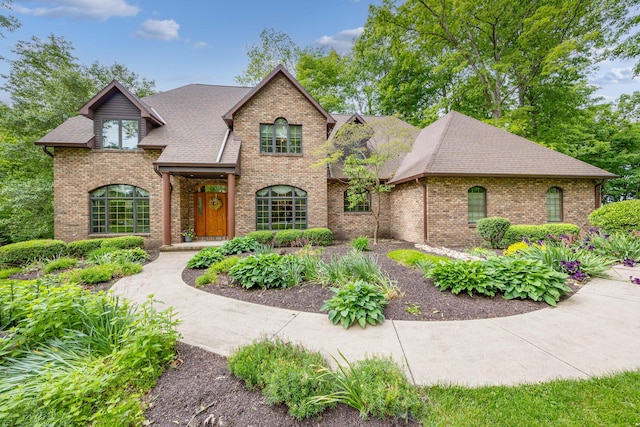 129 Tanglewood Dr, West Liberty, OH 43357 - view of front of house featuring brick siding and a shingled roof