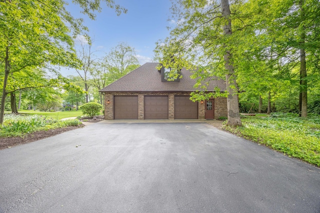 129 Tanglewood Dr, West Liberty, OH 43357 - garage featuring asphalt driveway