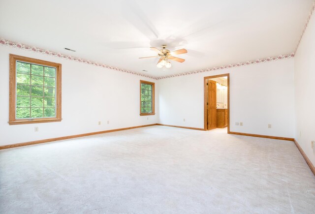 129 Tanglewood Dr, West Liberty, OH 43357 - empty room with baseboards, a ceiling fan, and light carpet