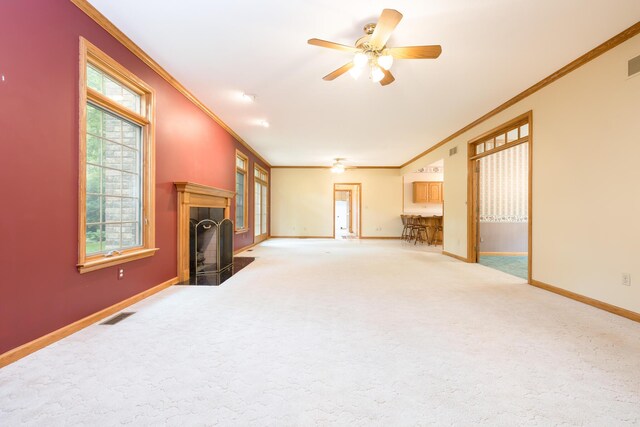 129 Tanglewood Dr, West Liberty, OH 43357 - unfurnished living room featuring a fireplace with flush hearth, ornamental molding, baseboards, healthy amount of natural light, and carpet flooring