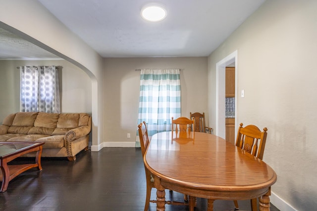 1920 Coventry Rd, Dayton, OH 45420 - dining room with arched walkways, baseboards, healthy amount of natural light, and dark wood-style flooring