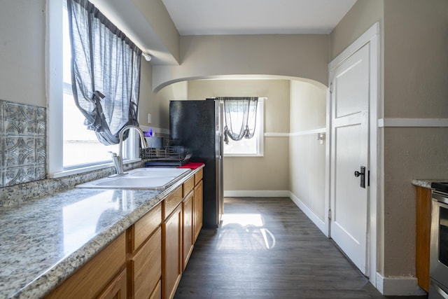 1920 Coventry Rd, Dayton, OH 45420 - kitchen featuring a sink, plenty of natural light, brown cabinets, and dark wood-style flooring