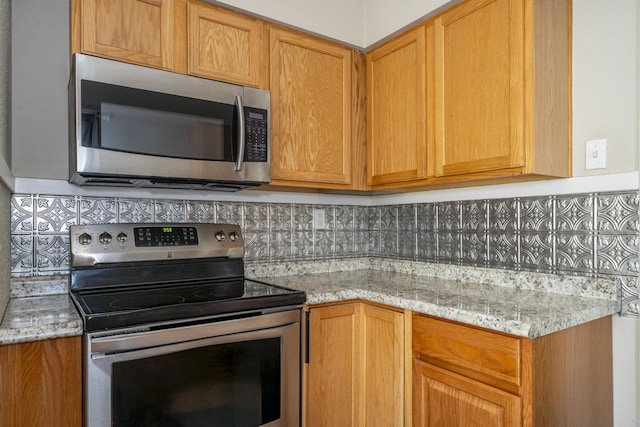 1920 Coventry Rd, Dayton, OH 45420 - kitchen featuring appliances with stainless steel finishes, backsplash, and light stone counters