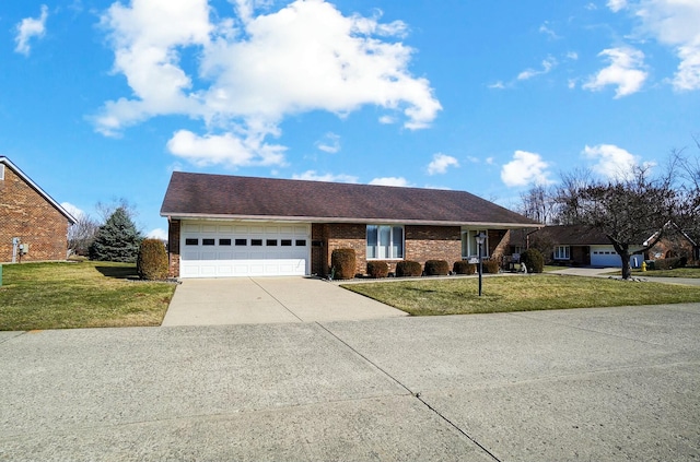 ranch-style house featuring a garage, concrete driveway, brick siding, and a front yard